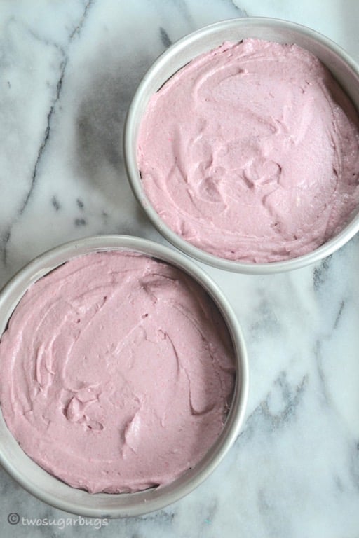 raspberry cake batter in prepared pans