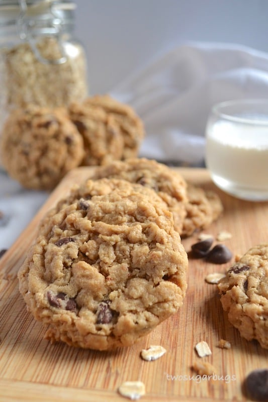 cookies on a cutting board with a cup of milk in the background