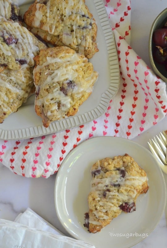 Cherry almond scones piled on a plate.
