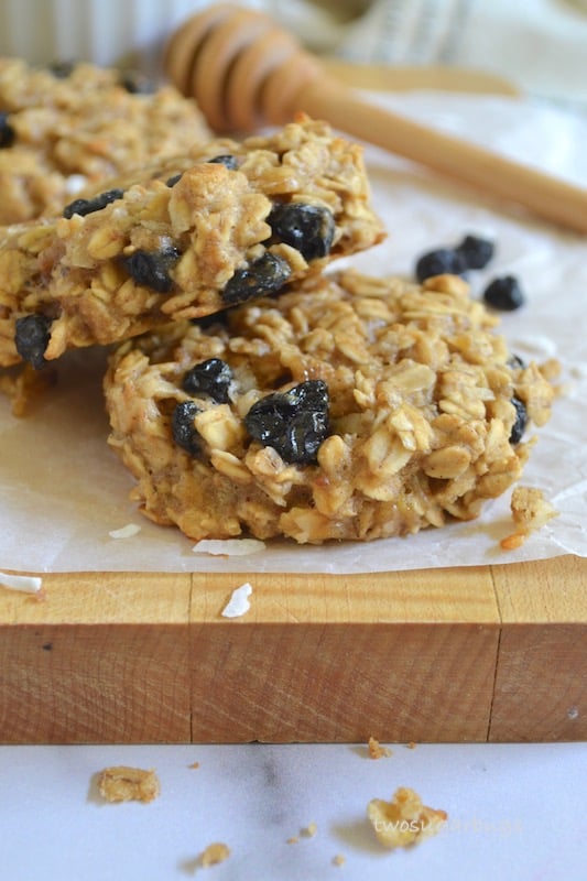 Two breakfast cookies on a cutting board