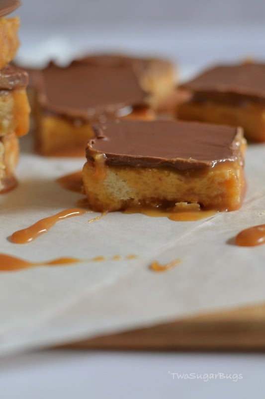 Chocolate caramel slice bar on parchment paper