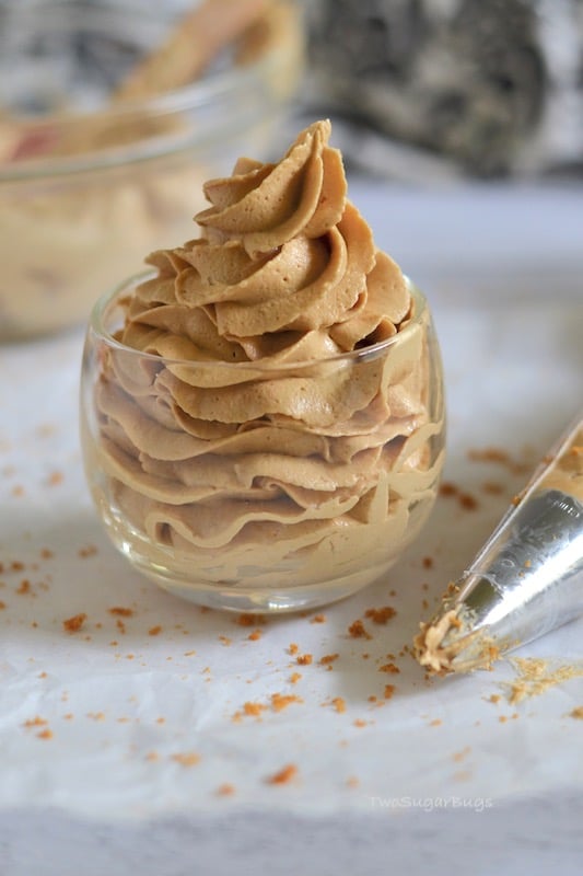 an over-flowing glass of cookie butter frosting