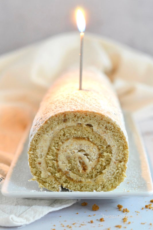 Cookie butter Swiss roll with a lit candle.