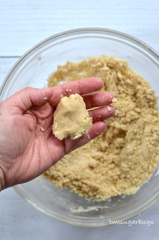 brown butter shortbread dough in a hand