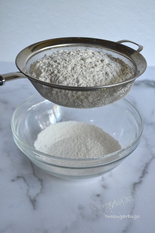 Flour being sifted into a bowl