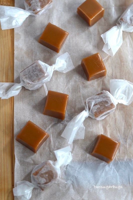 wrapped and unwrapped caramels on parchment paper