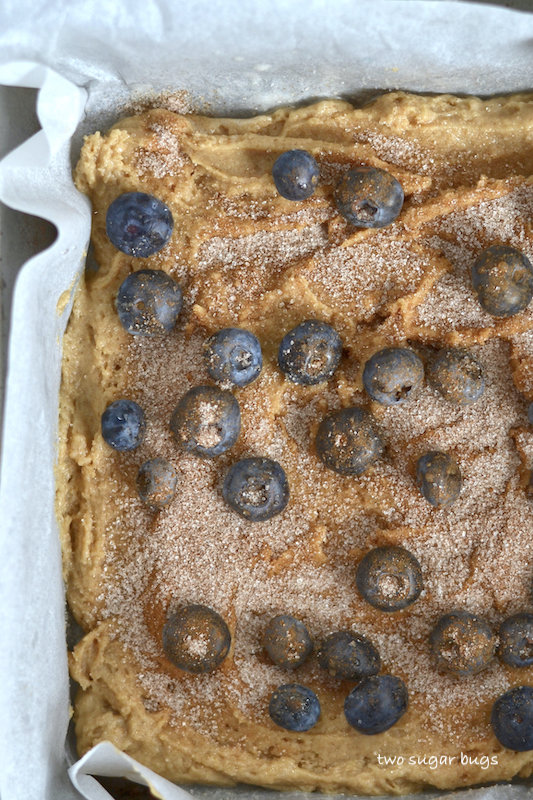 unbaked cake with blueberries and cinnamon sugar on top