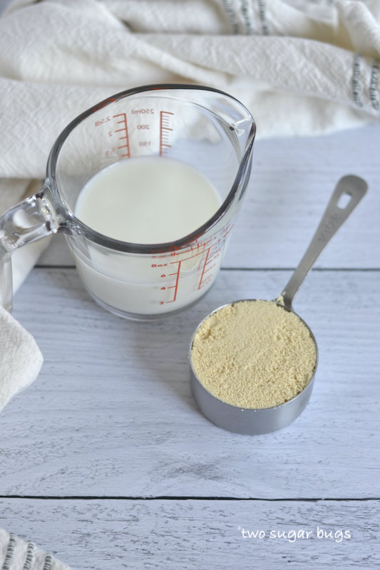 milk and malted milk powder in measuring cups