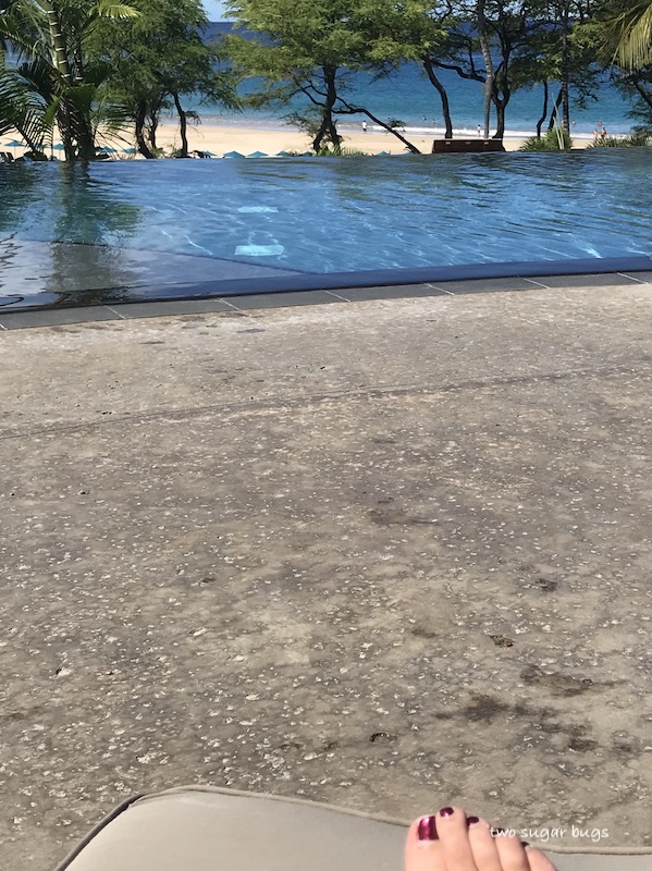pool deck with the beach in the background