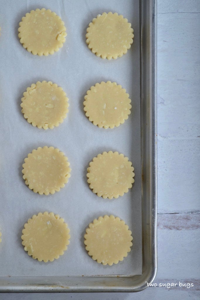 unbaked cookies on a parchment lined cookie sheet