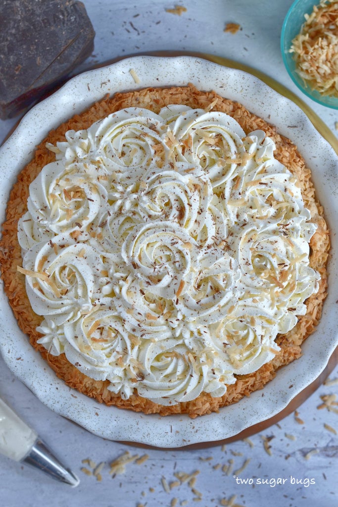 finished pie with chocolate, toasted coconut and whipped cream surrounding