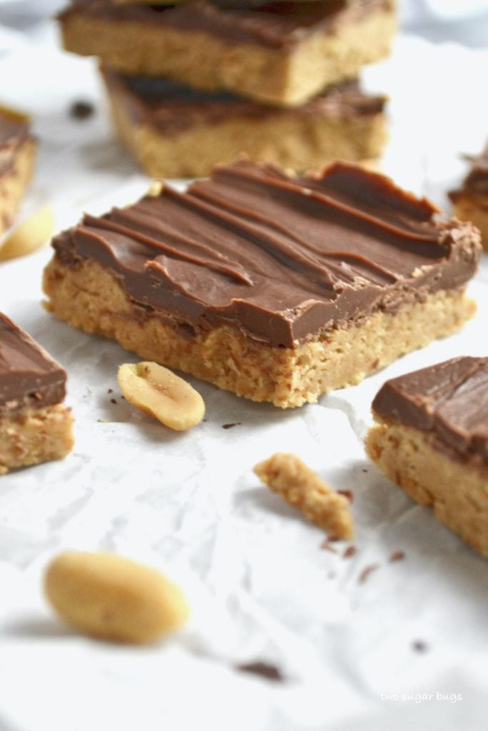 close up of peanut butter bars sitting on parchment paper