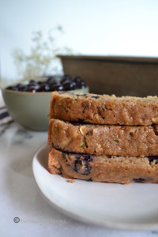 Wholesome and healthier zucchini blueberry bread. You'll feel good feeding this one to your family! #twosugarbugs #zucchinibread #healthierzucchinibread #breakfastisserved