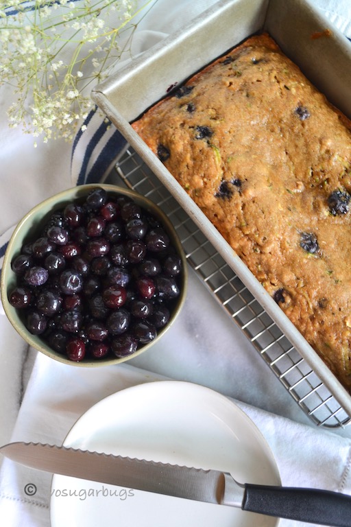 Wholesome and healthier zucchini blueberry bread. You'll feel good feeding this one to your family! #twosugarbugs #zucchinibread #healthierzucchinibread #breakfastisserved