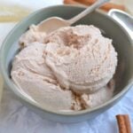 Cinnamon ice cream in a bowl with a spoon
