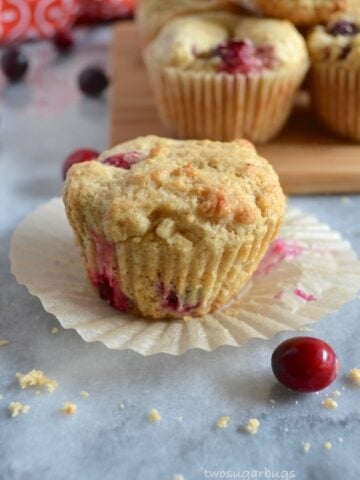 Cranberry Orange Muffins - delcious and bright. Perfect for all your holiday brunches. #twosugarbugs #thiscelbratedlife #cranberryorangemuffins