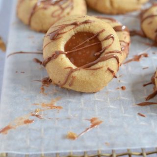 Melt in your mouth brown sugar shortbread, filled with homemade caramel sauce and drizzled with milk chocolate. It will be love with first bite! #twosugarbugs #brownsugarshortbread #homemadecaramel #caramelcookies