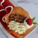 white and dark chocolate mousse in a tulip cup on decorated plate