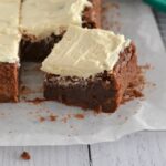 Fudgy Irish Cream Brownies topped with a fluffy Irish cream buttercream. Perfect for St. Patrick's Day or honestly anytime! #twosugarbugs #irishcreambrownies #brownielove #bestbrownie