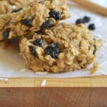 Two breakfast cookies on a cutting board