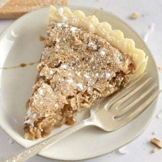 Slice of tart on a plate with a fork.