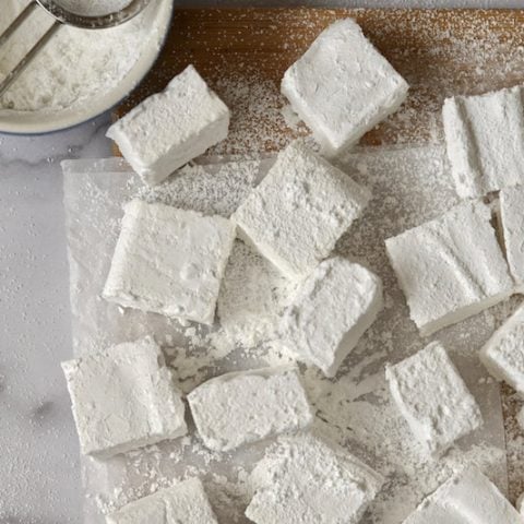 Overhead shot of homemade marshmallows on a cutting board.