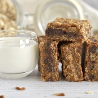 Pumpkin caramel spice bars leaned next to a glass of milk.