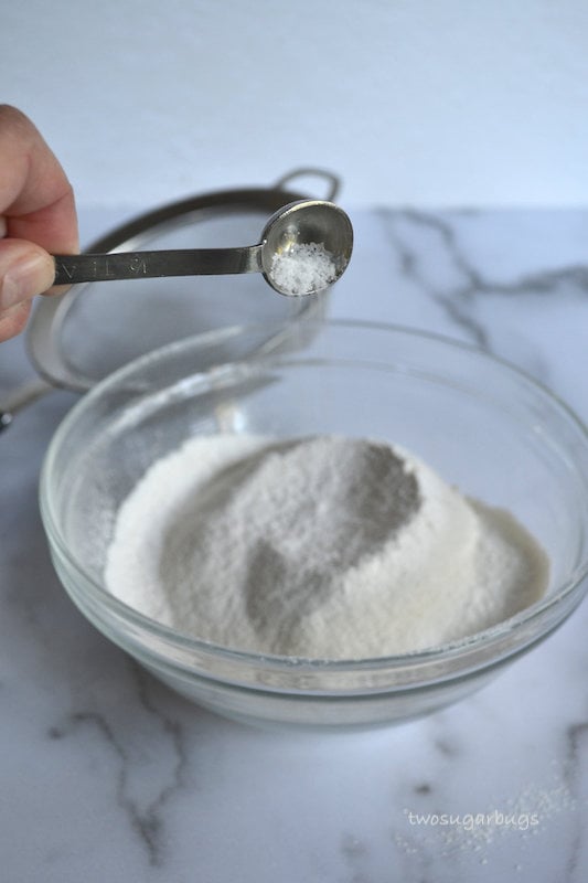 Salt being poured into a bowl