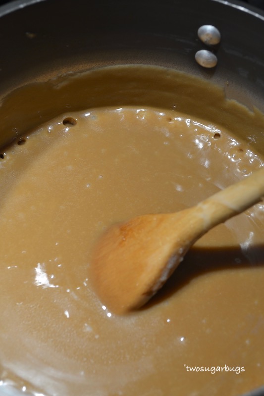 homemade caramel mixture at a low boil in a saucepan