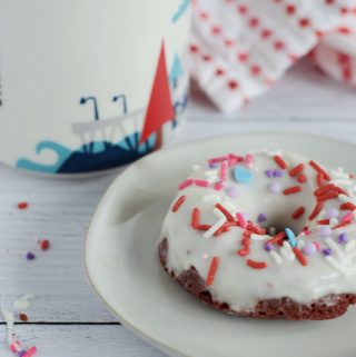 donut on a plate with a coffee mug