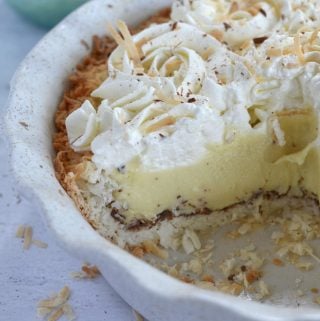a pie plate with a missing piece; showing the layers of the coconut cream pie