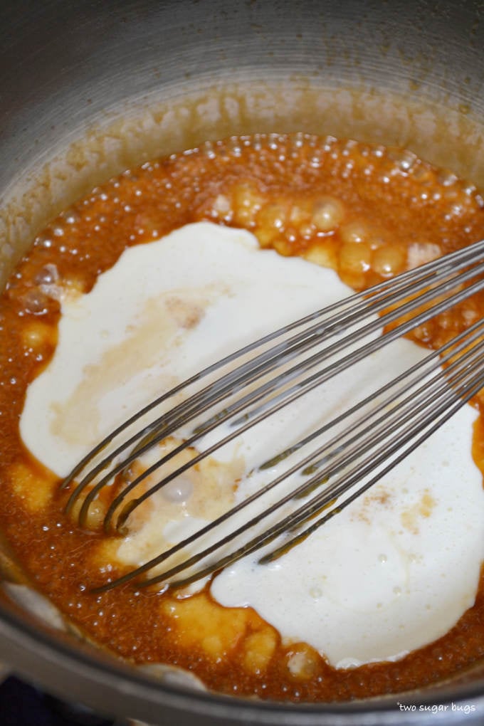 caramel sauce with heavy cream added in a sauce pan