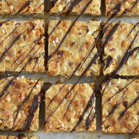 close up of nut bars with chocolate drizzled over the tops.