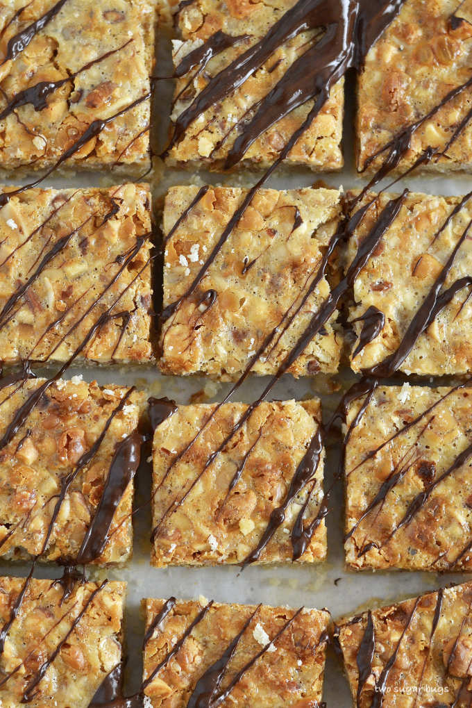 close up of nut bars with chocolate drizzled over the tops.