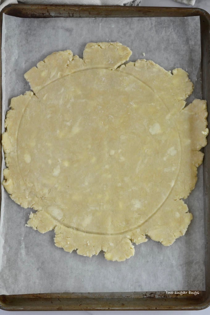 crostata dough rolled out on a baking pan