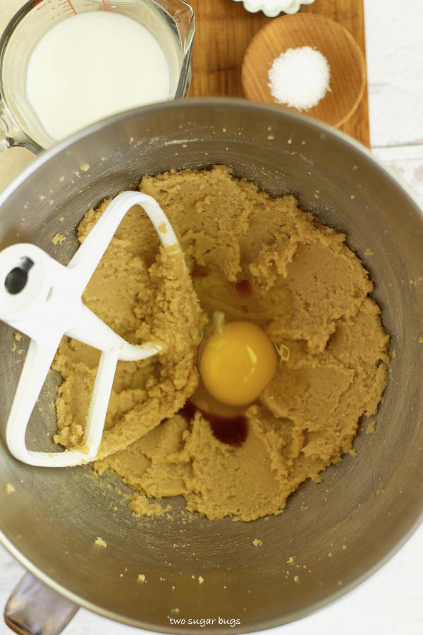cupcake batter with an egg and vanilla added in the mixing bowl