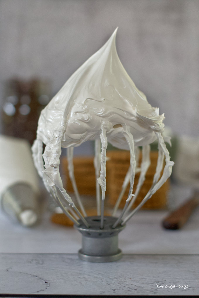 Beater whisk showing a meringue stiff peak