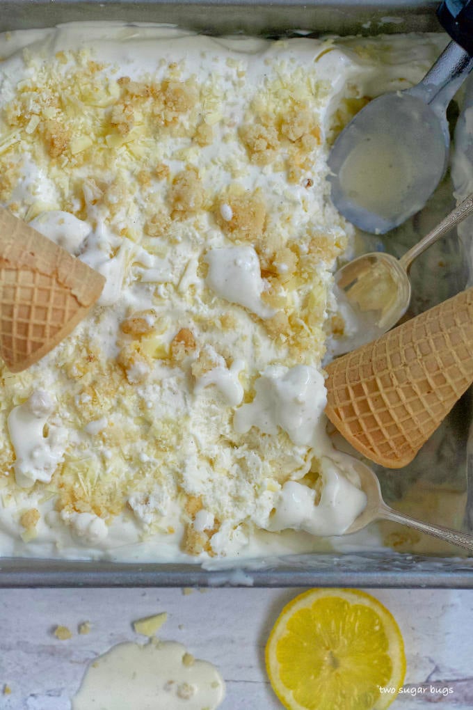 ice cream with spoons and ice cream cones in the container