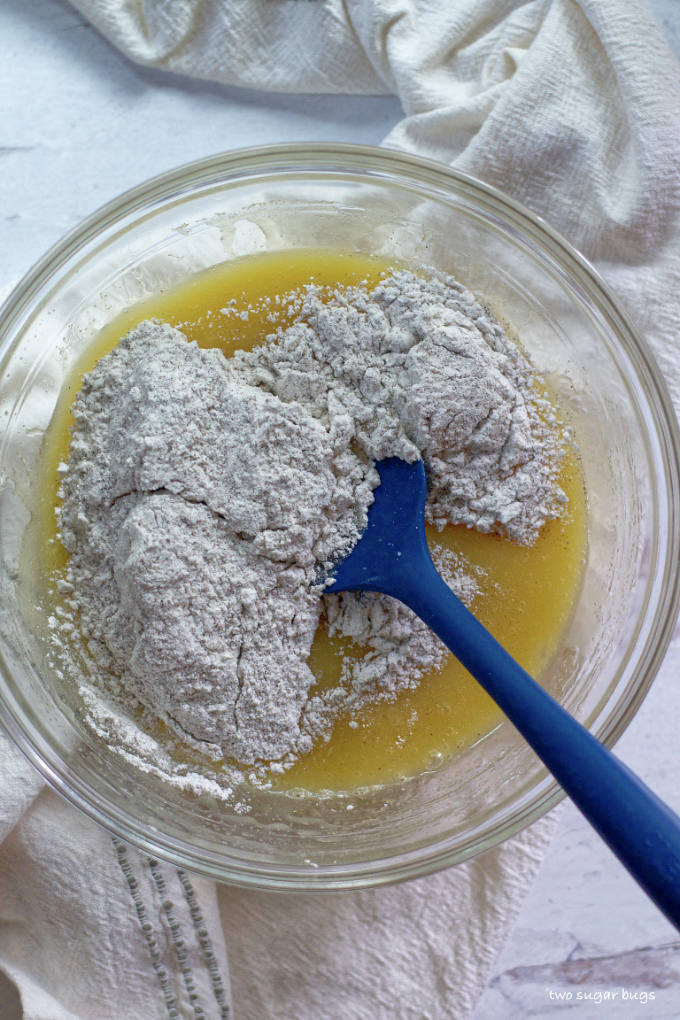 wet and dry ingredients in a bowl with a spatula