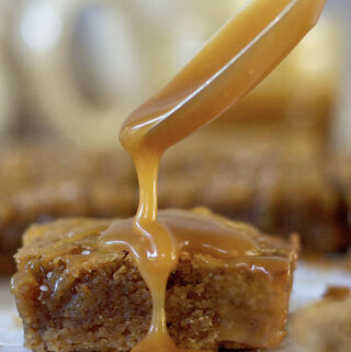 spoon drizzling salted caramel over an espresso bar