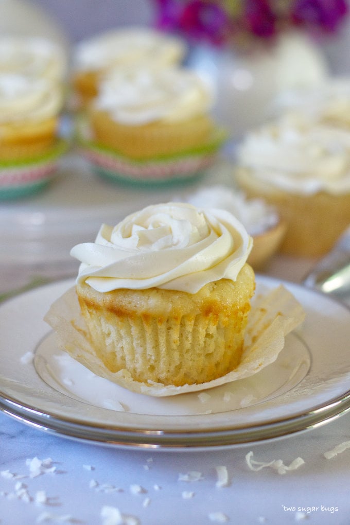 vanilla rum coconut cupcake with the wrapper pulled off
