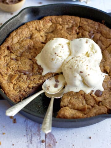 skillet cookie with ice cream and two spoons