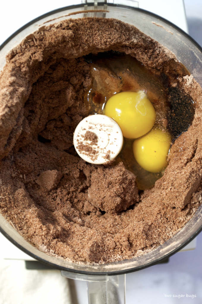 dry ingredients in a food processor with eggs and vanilla added