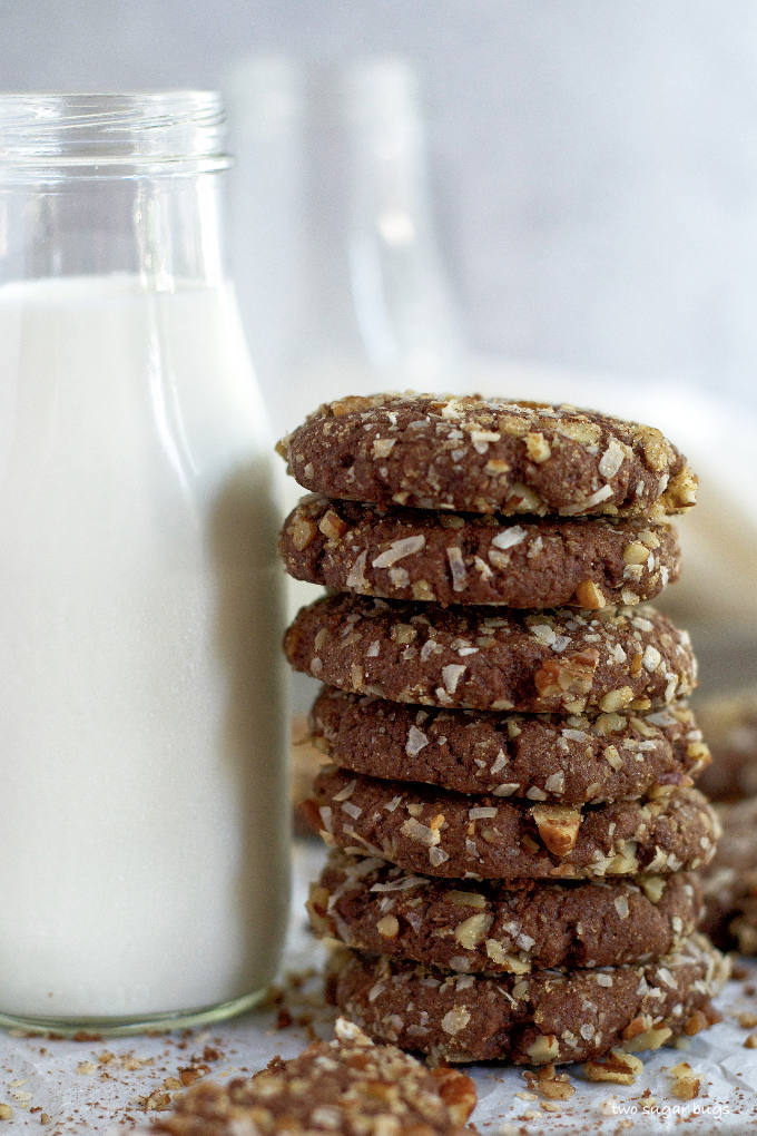 tall stack of easy German chocolate cookies next to a jar of milk