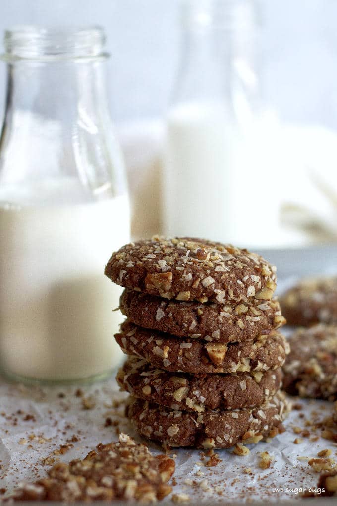 stack of cookies with milk in the background
