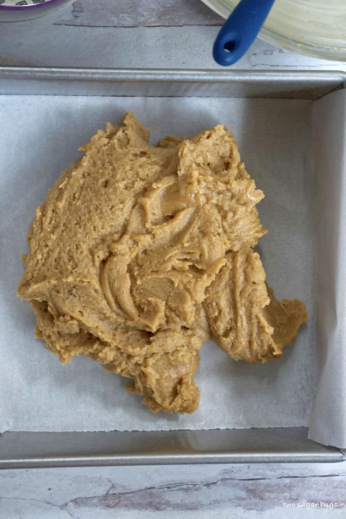 peanut butter batter in the baking pan before it's spread out