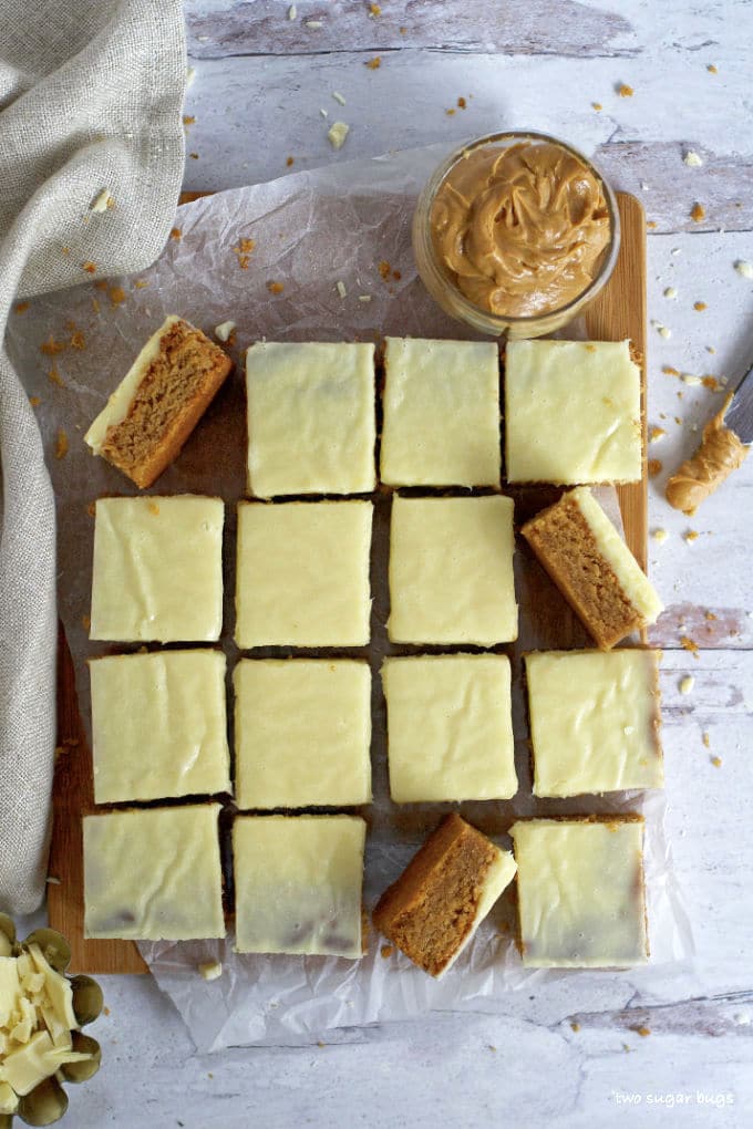 overhead shot of peanut butter white chocolate blondies with a jar of peanut butter