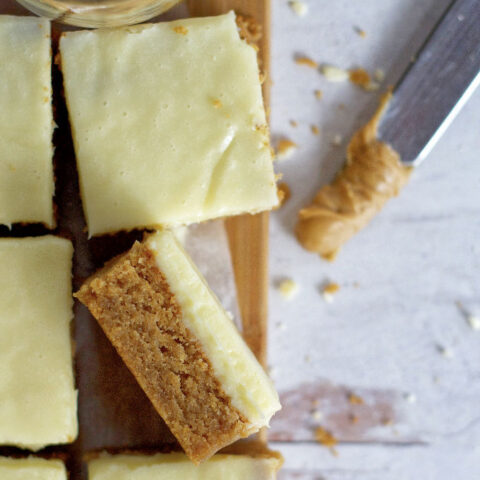 close up of a peanut butter white chocolate blondie on it's side