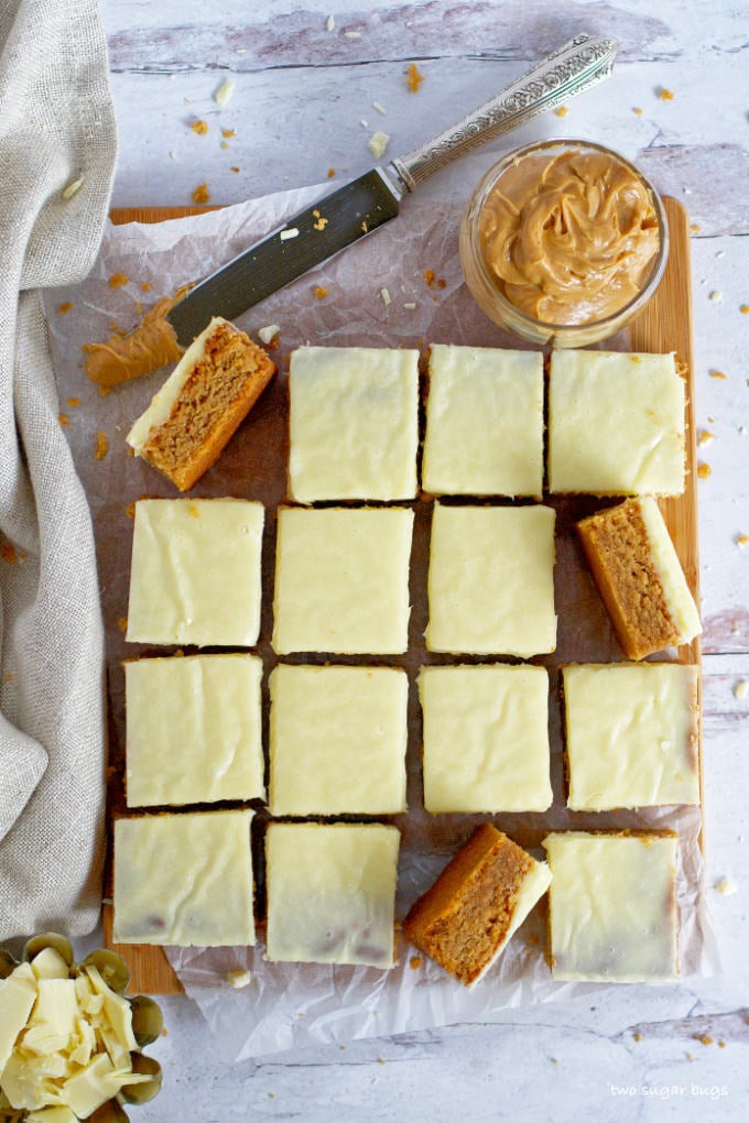 peanut butter blondies on a parchment lined cutting board