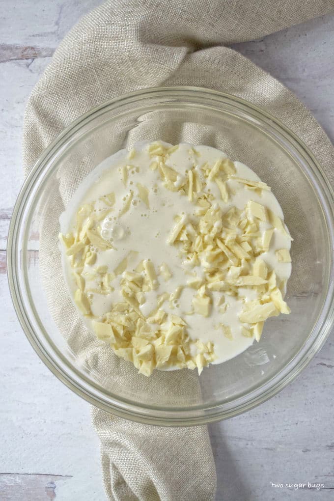 chopped white chocolate and heavy cream in a bowl